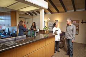 Patients and staff talking in office at La Jolla Dental Spa