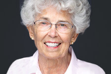 Older woman with grey hair smiling