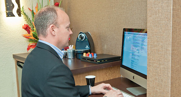 Man on computer browsing online at dental office